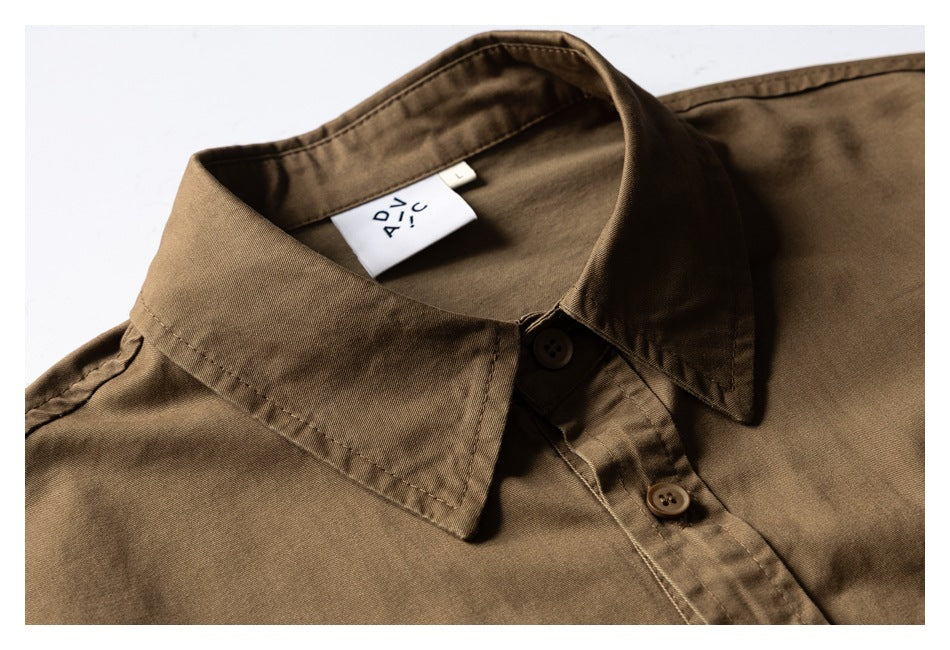 Close-up of a brown button-up shirt collar, placket, and neck label.
