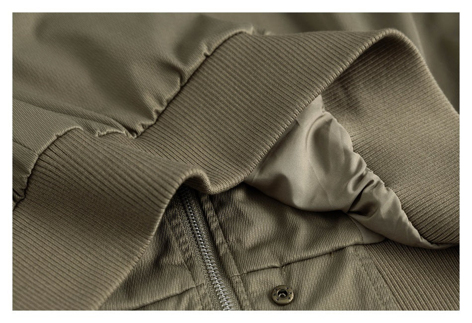 Close-up of the olive jacket's ribbed collar, zipper, snap, and inner lining.