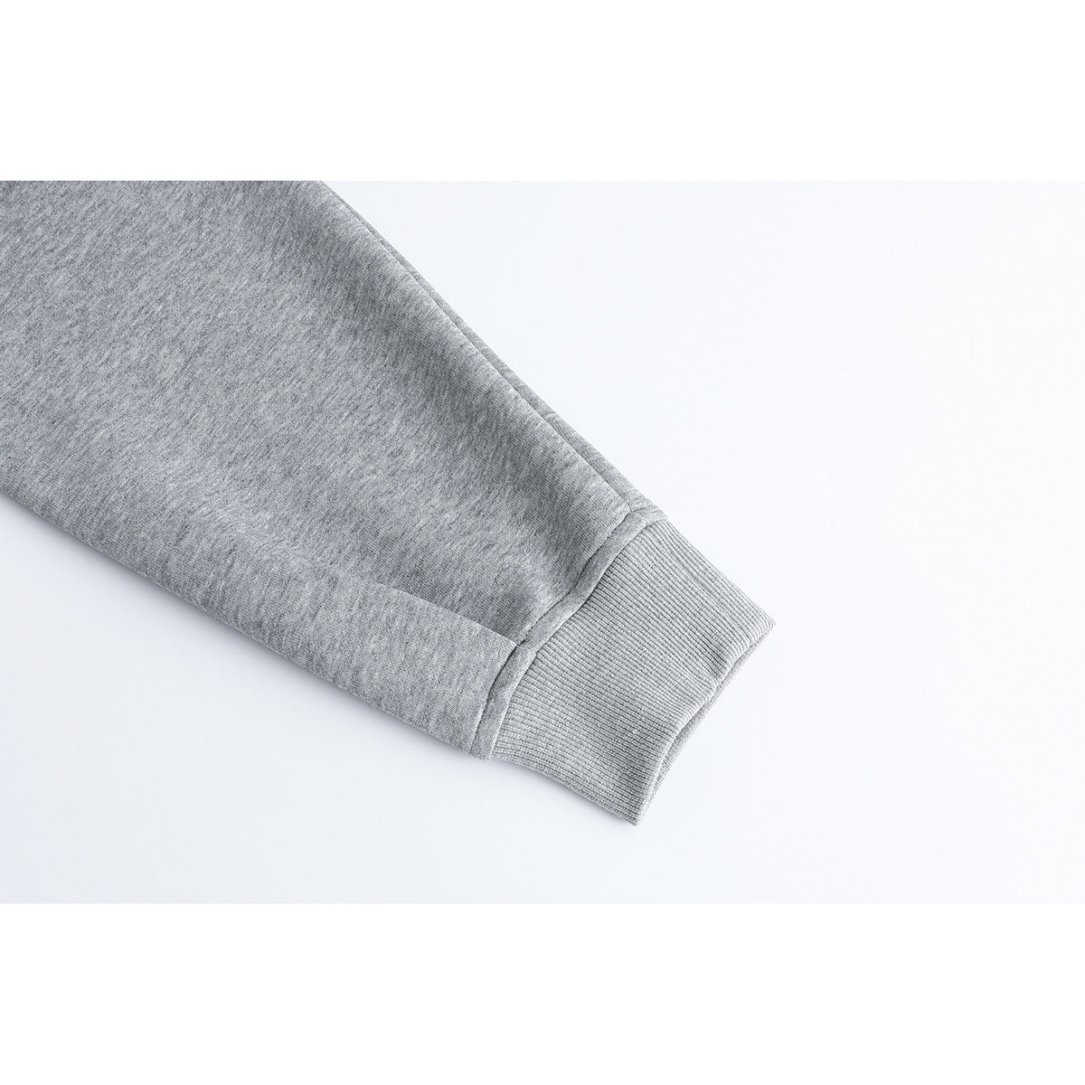 Close-up of a light gray sleeve ending in a ribbed cuff.