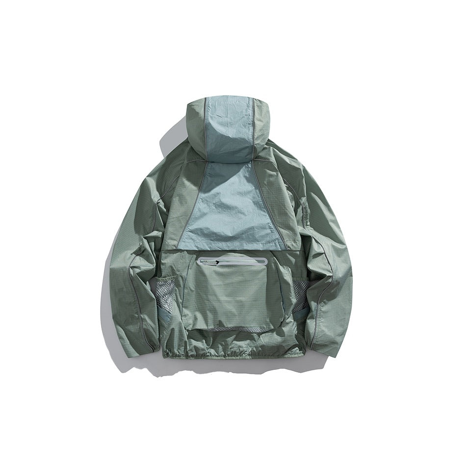 Back view of a pale sage hooded jacket with a large rear pocket and mesh side panels.
