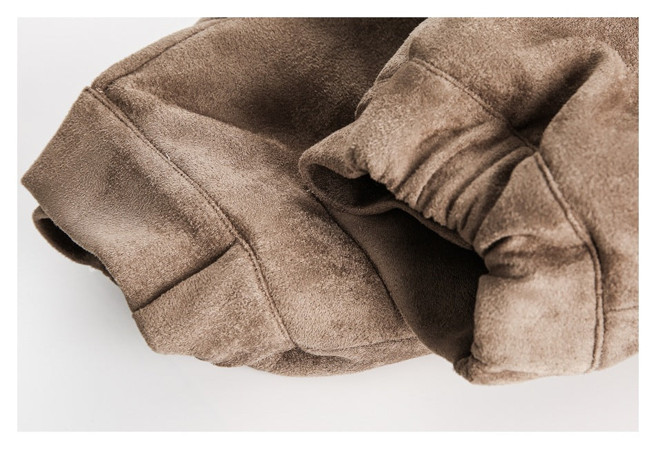 Close-up of a brown jacket sleeve and cuff with visible seams and gathered stitching.