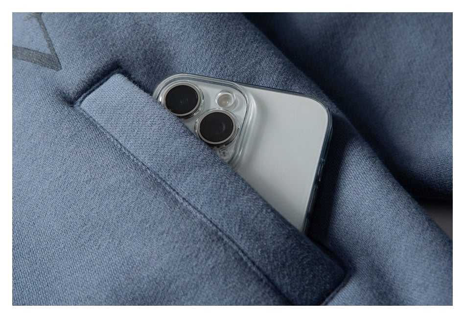 Close-up of a blue garment pocket holding a smartphone.
