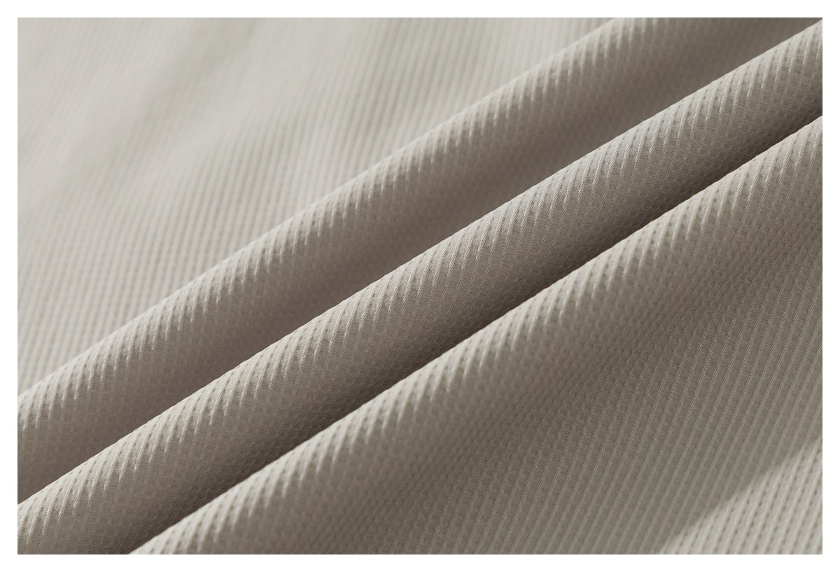 Macro view of the light taupe shirt’s fine, closely spaced ribbed fabric texture.