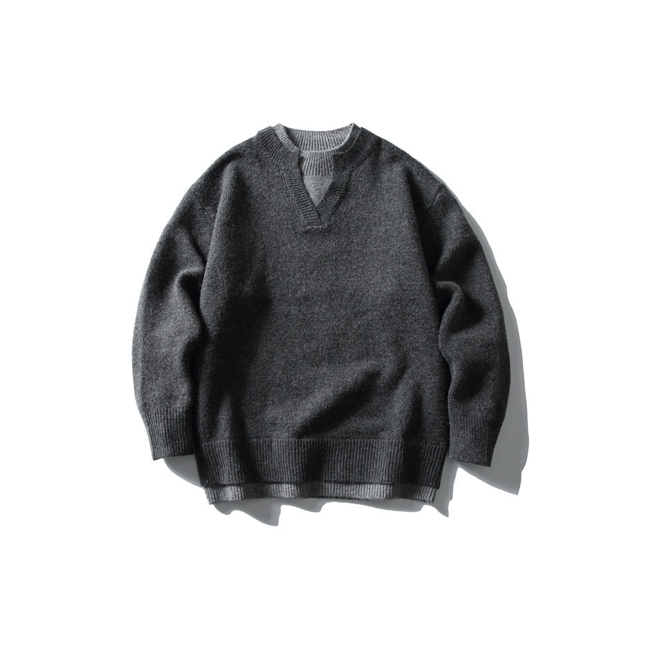 Dark gray knit pullover sweater with notched V-neck and gray layered trim, flat lay front view