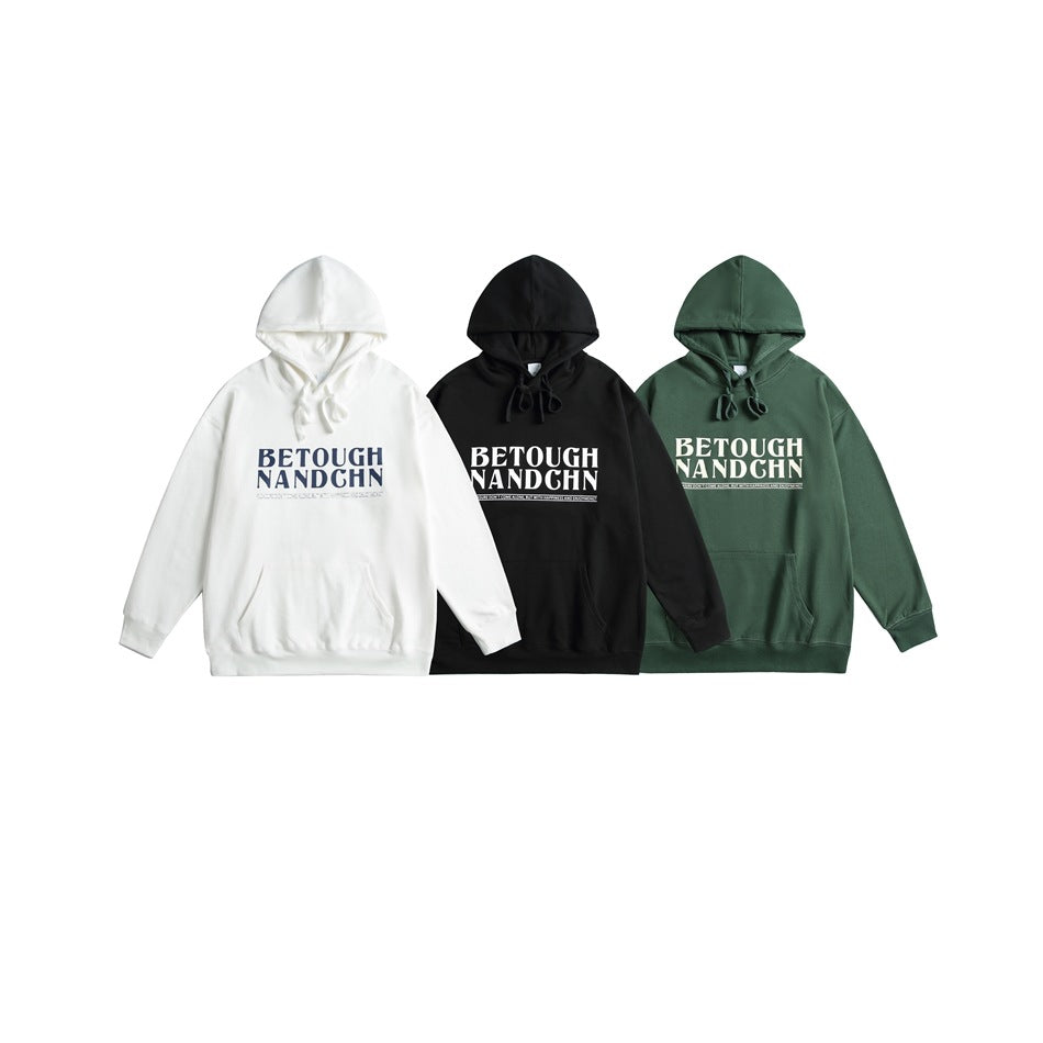 Three front-view pullover hoodies with chest lettering, shown in white, black, and dark green.