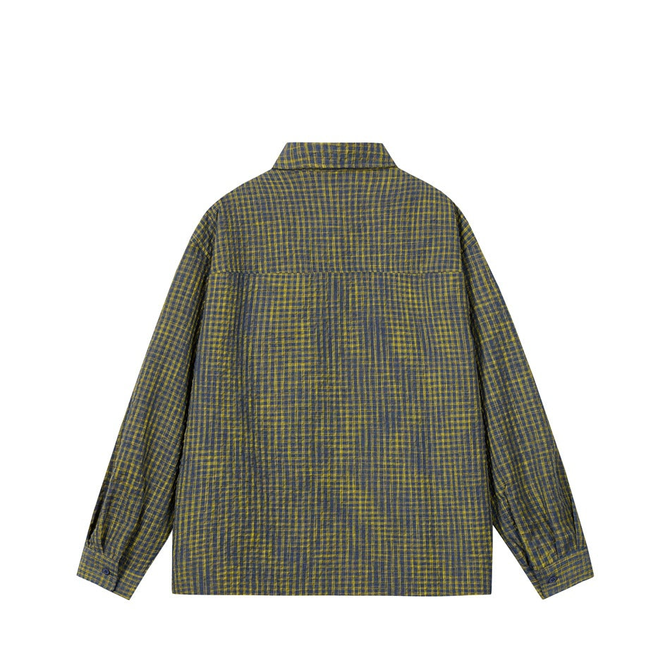 Back view of blue-gray and yellow check long-sleeve shirt showing yoke seam and buttoned cuffs