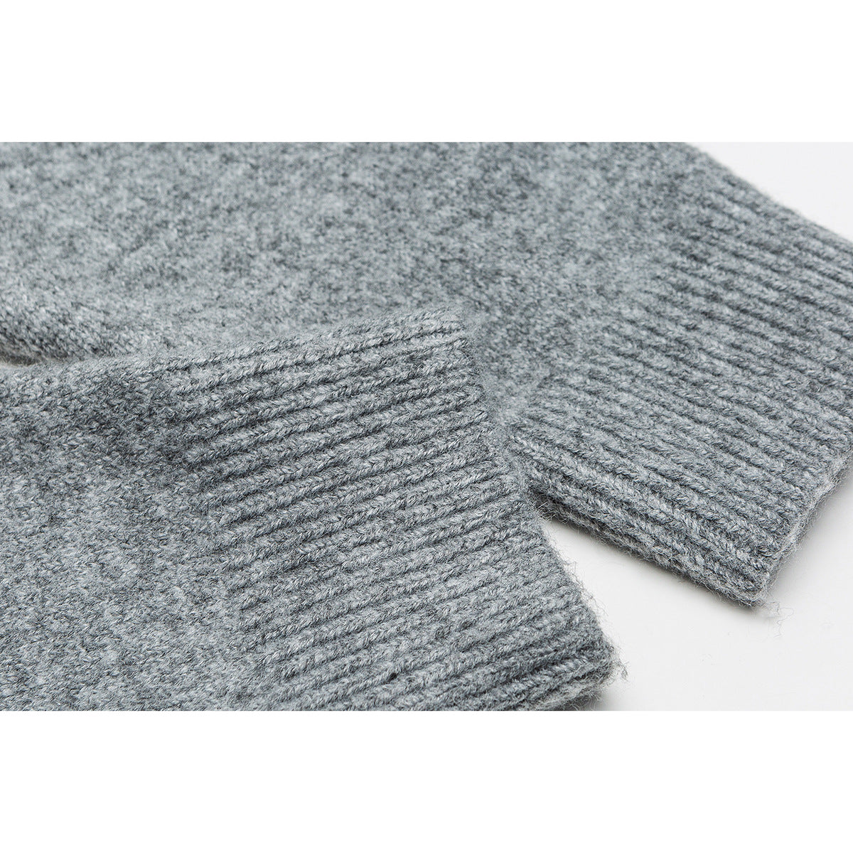 Close-up of the gray cardigan's ribbed sleeve cuffs and knit texture.