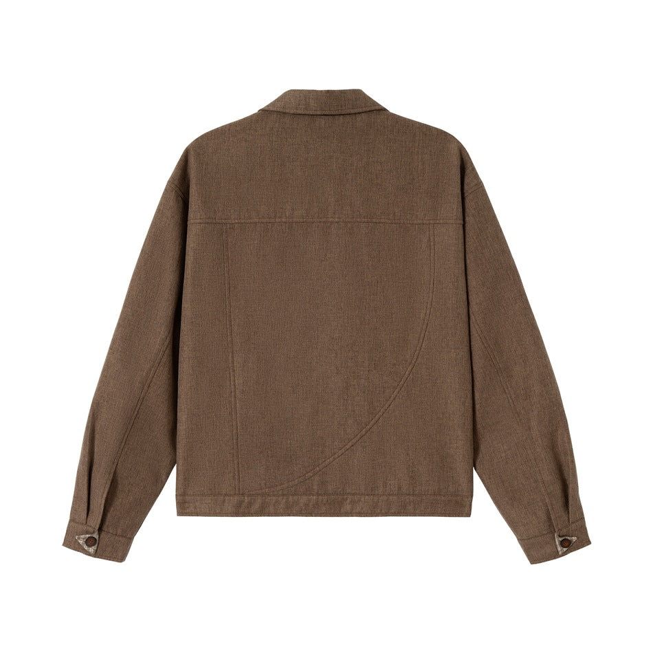 Back view of a brown jacket with a collar, long sleeves, curved seam detailing, and buttoned cuffs.
