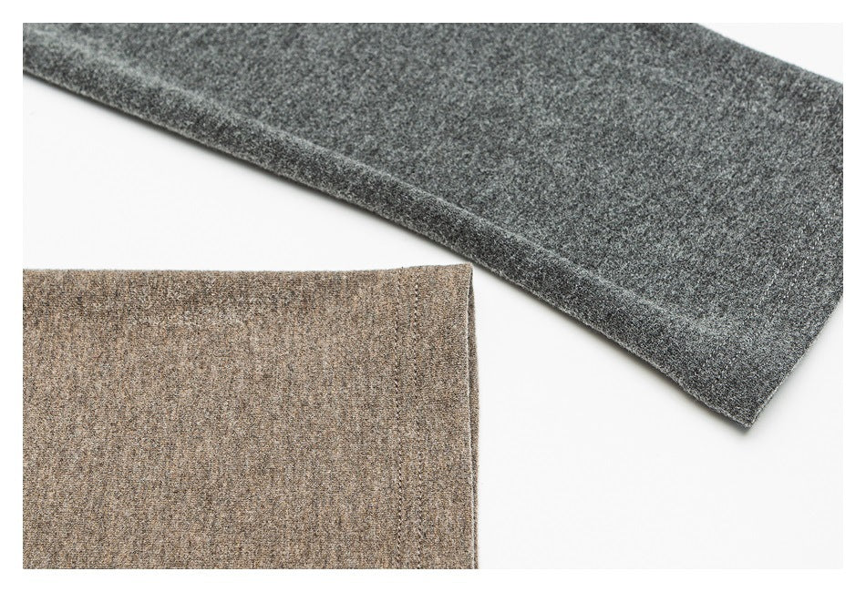 Close-up of taupe and charcoal heathered garment sections with finished edges on a white background.