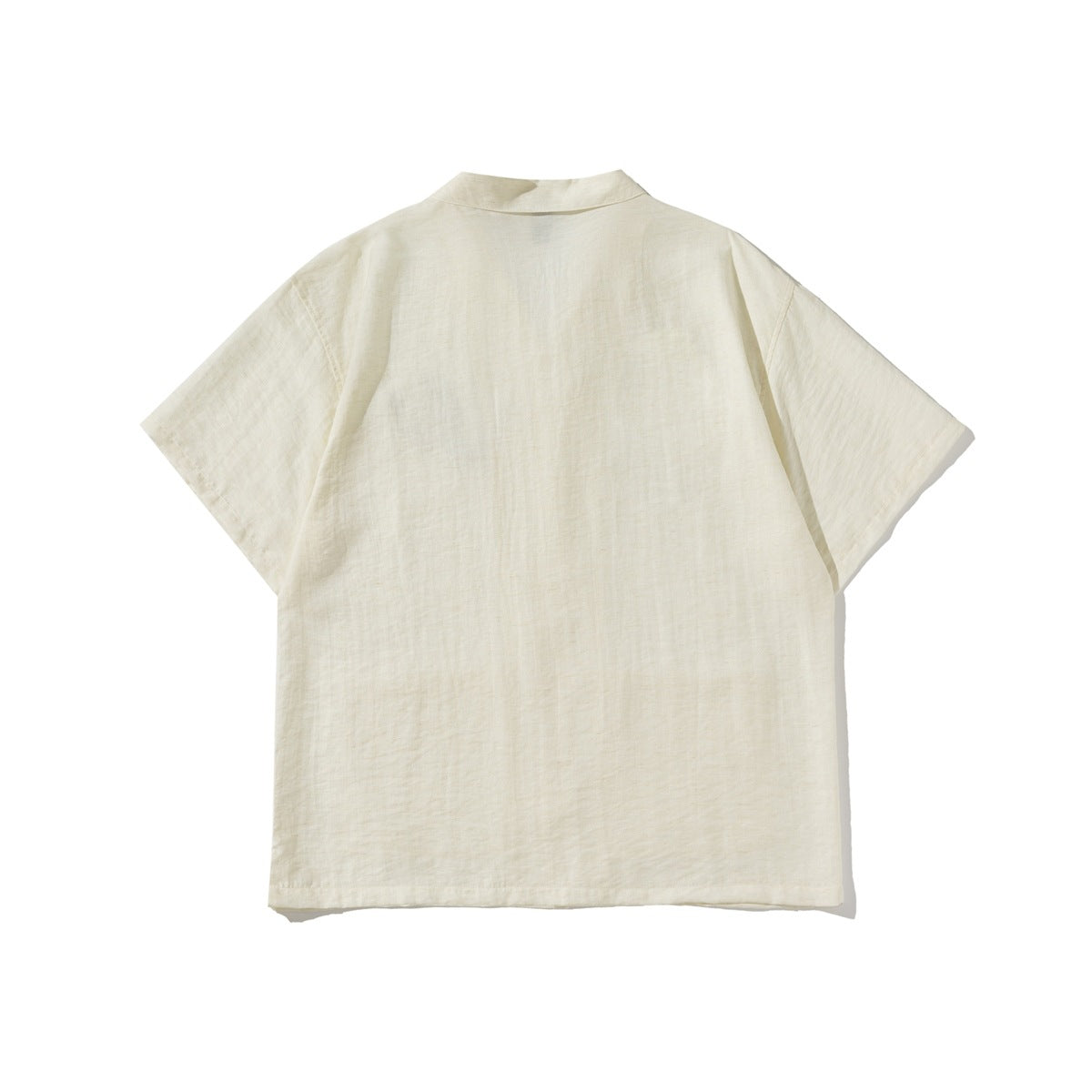 Back view of an ivory short-sleeve collared shirt laid flat against a white background.