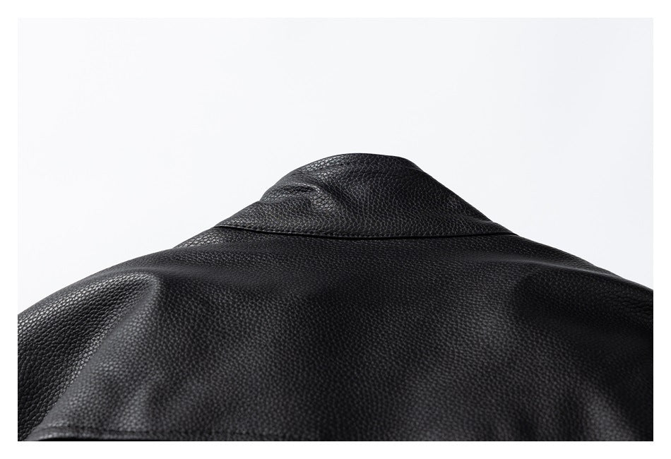 Close-up of the back collar and shoulder seam of a black pebbled jacket.