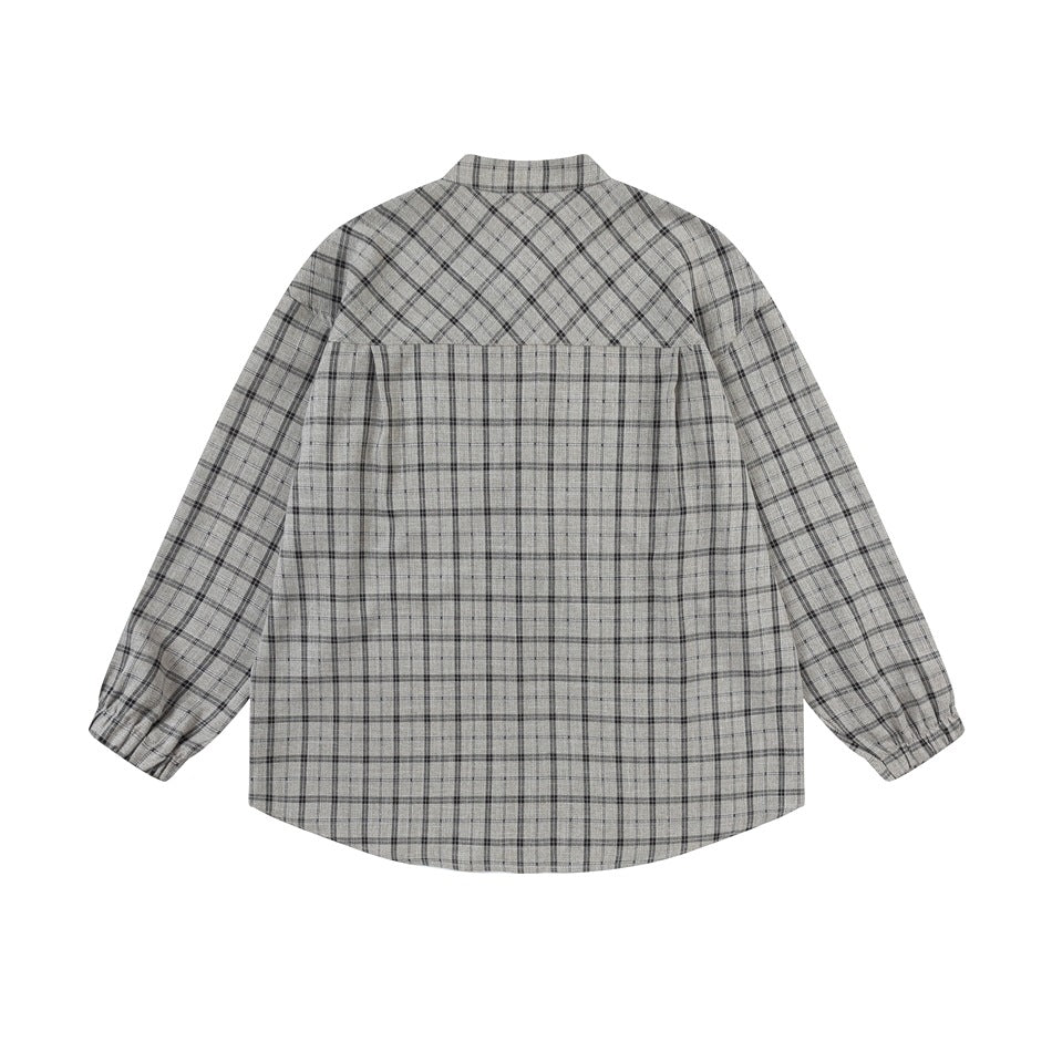 Back view of a gray plaid blouse laid flat, with a gathered yoke, long sleeves, elastic cuffs, and a curved hem.