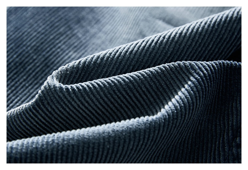Macro view of the raised ribs and texture of blue-gray corduroy fabric.
