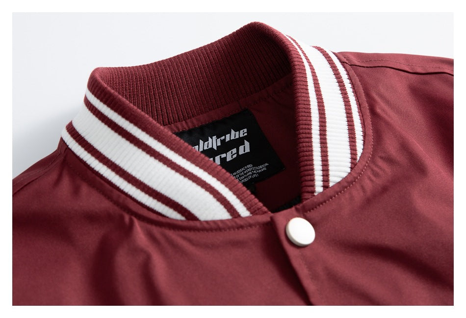 Close-up of the jacket’s burgundy-and-white striped ribbed collar, inner neck label, and a white snap.