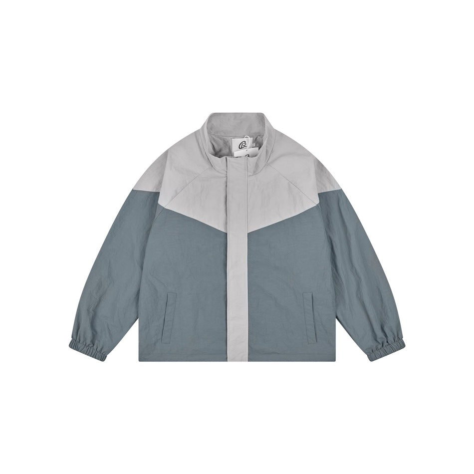 Gray-blue and light gray color-block stand-collar jacket flat lay, front view, with front pockets