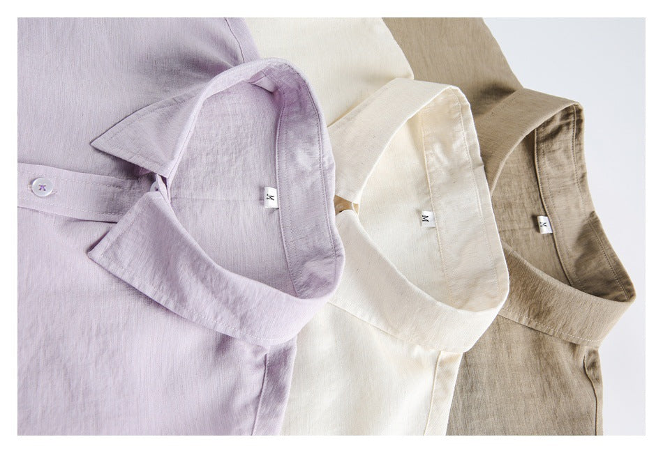 Close-up of three collared shirts in lavender, ivory, and taupe, arranged side by side.