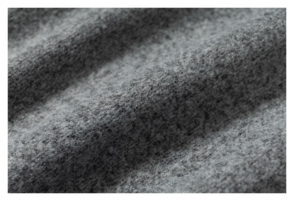 Extreme close-up showing the fuzzy surface texture of gray fabric.