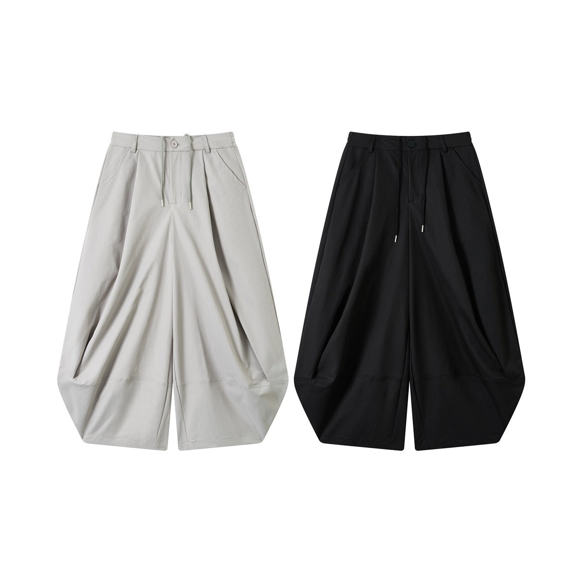 Front view of wide-leg pants in light gray and black, with drawcords, button closures and angled pockets.