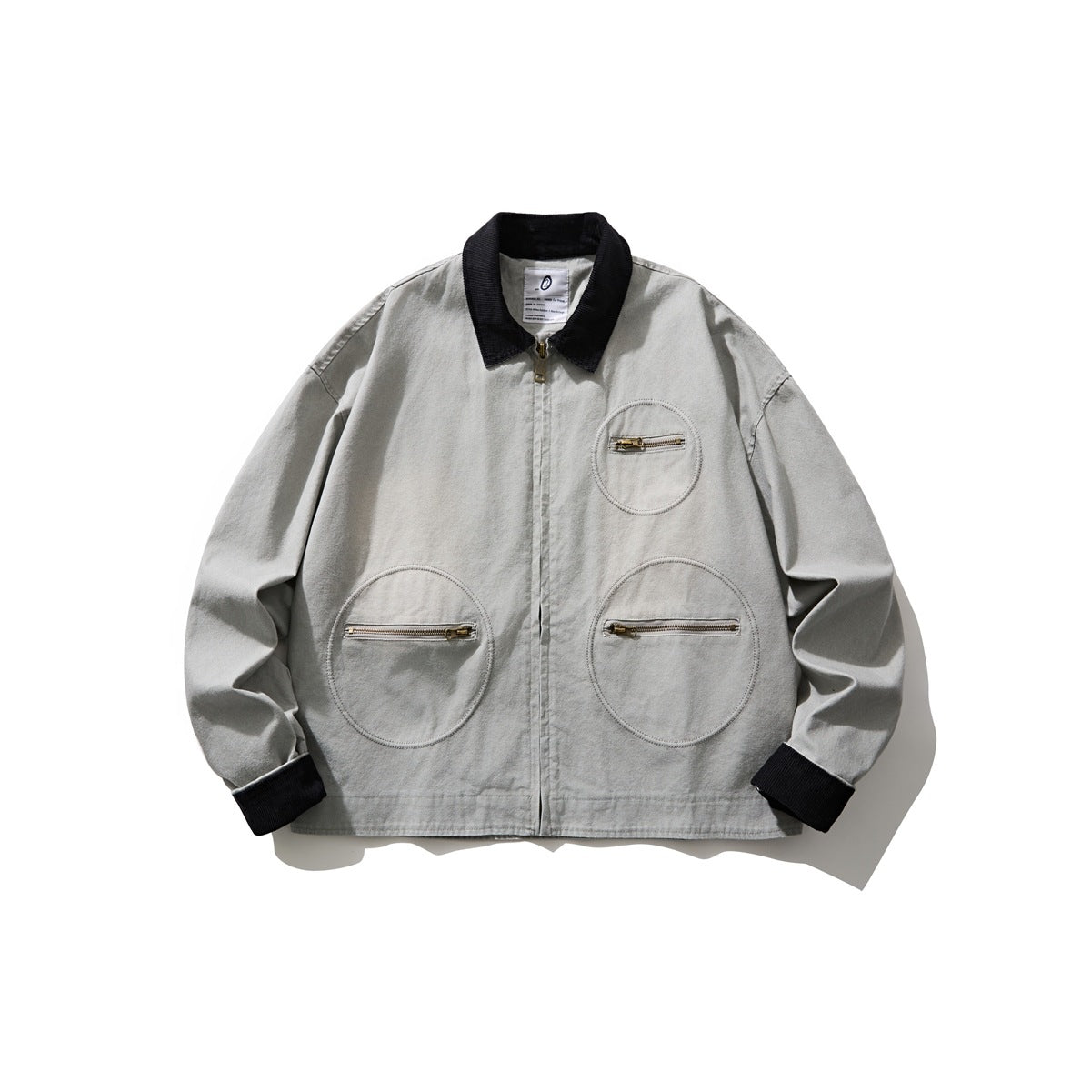 Light gray washed zip jacket with black corduroy collar and cuffs and three circular zip pockets, flat front view