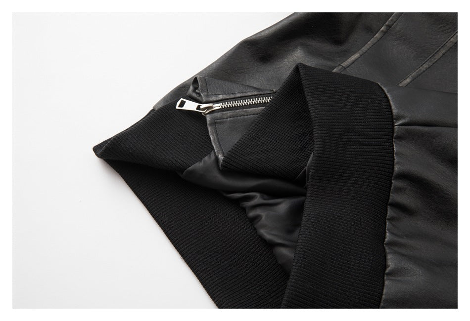 Close-up of a black jacket's ribbed waistband and a small silver zipper.