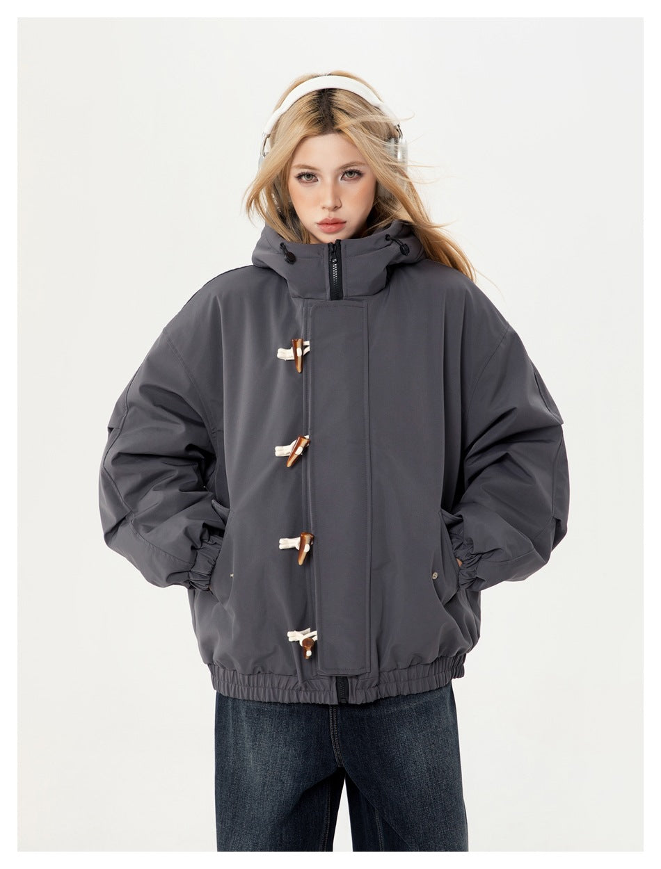 Model wearing a charcoal hooded jacket with a high collar, front zipper, wooden toggles, and elastic cuffs and hem.