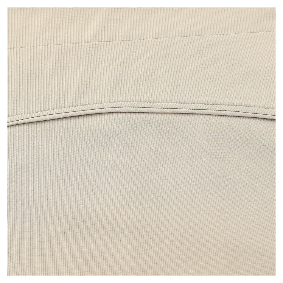 Close-up of beige ribbed fabric with a curved stitched seam.