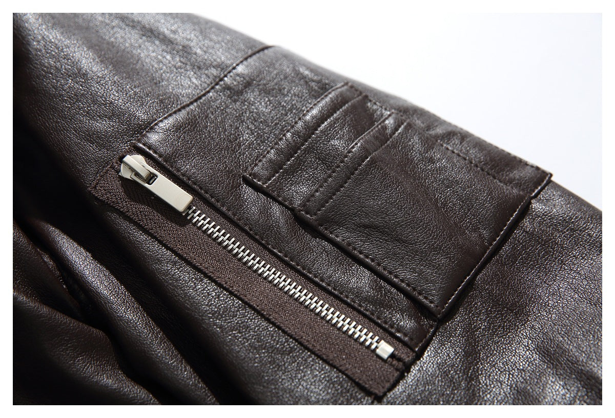 Close-up of a dark brown jacket’s silver zip pocket and stitched leather-like panel.