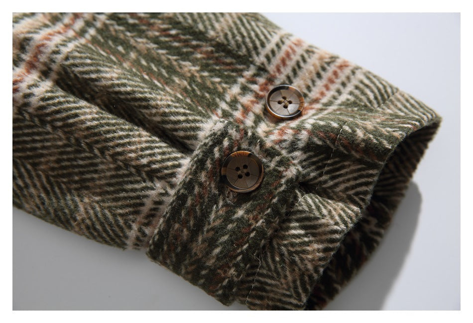 Close-up of two brown buttons on a cuff of a brown, olive, and cream plaid garment.