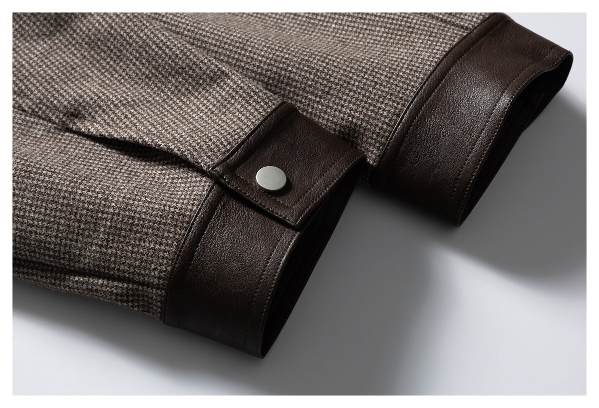 Close-up of a houndstooth jacket cuff with dark brown trim and a snap-fastened tab.