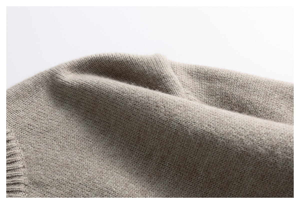 Close-up of the soft-looking taupe knit fabric, draped to show its fine stitch texture.