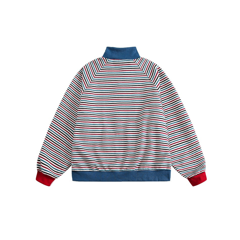 Back view of a white jacket with thin red, teal, and black stripes, a blue collar and hem, and red cuffs.