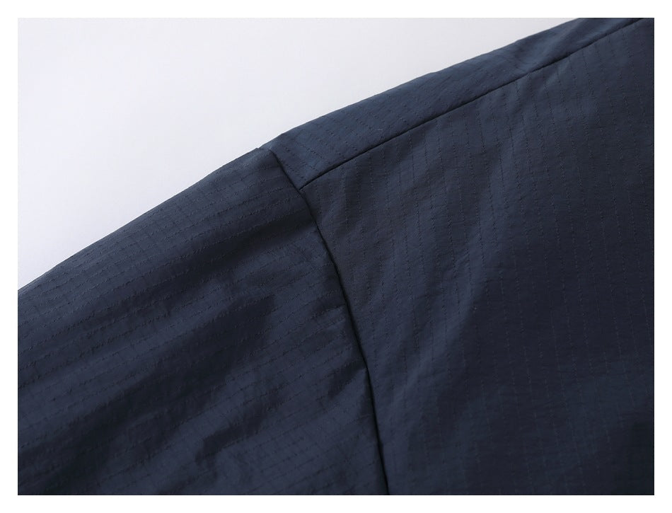 Close-up of dark navy fabric with subtle stitched lines and a curved seam.