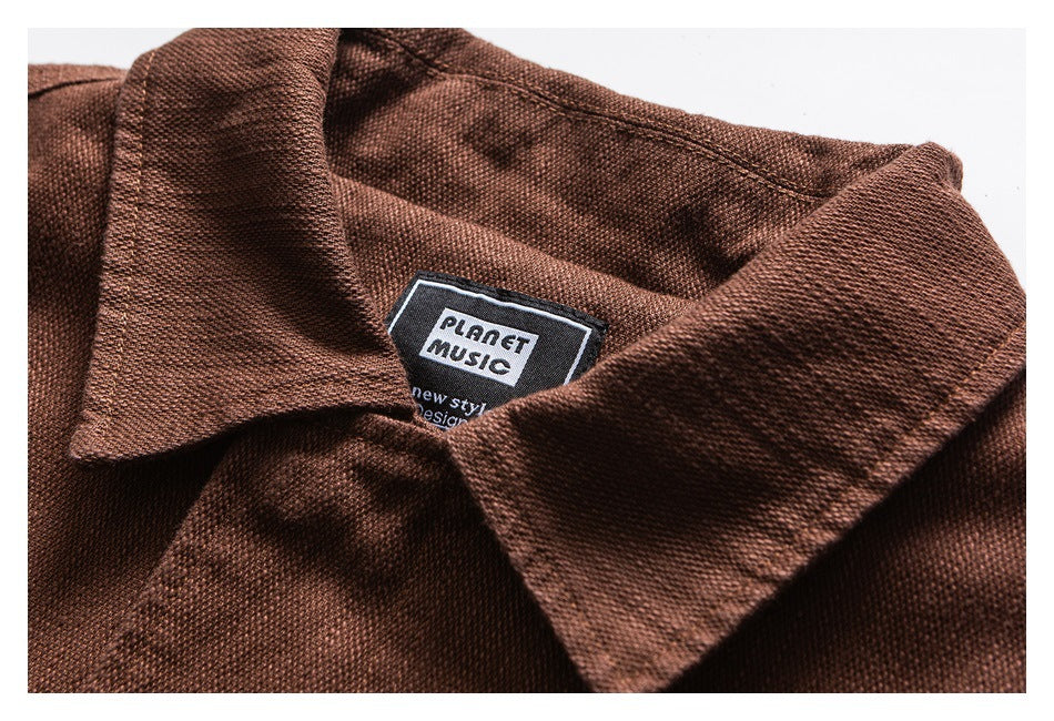 Close-up of a brown jacket collar and inner label reading “PLANET MUSIC.”