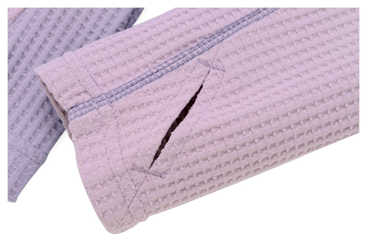 Close-up of a mauve jacket sleeve with gray contrast stitching and a narrow cuff opening.