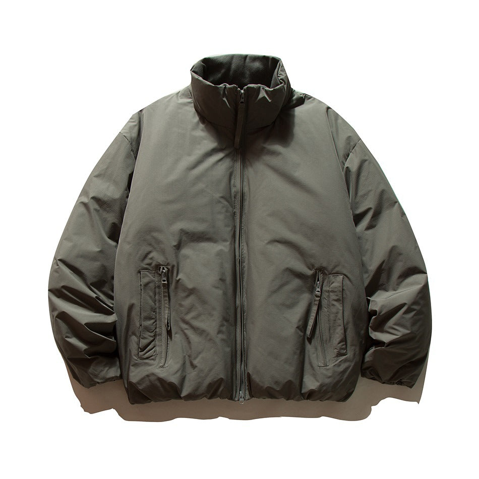 Dark gray puffer jacket with stand collar, front zipper and two zippered pockets, flat lay front view