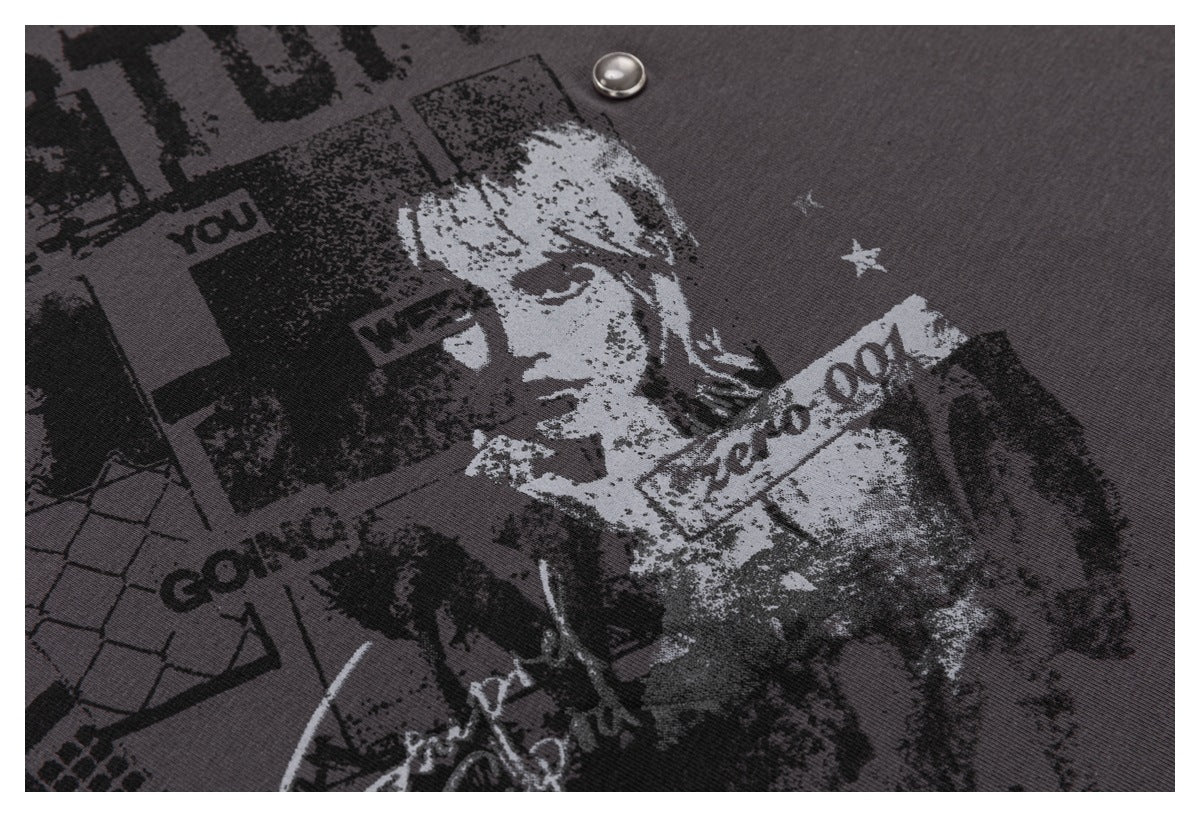 Close-up of the distressed portrait and collage-style graphic printed on charcoal fabric.