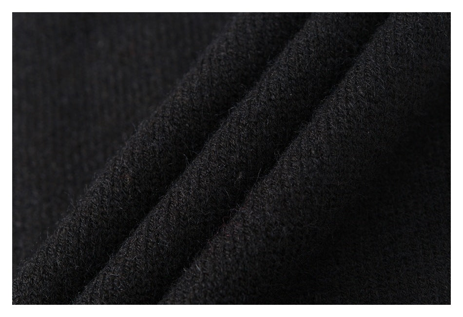 Macro view of the black garment's soft, fuzzy knit texture and folded fabric.
