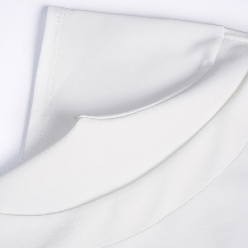 Close-up of white T-shirt fabric layers and stitched sleeve edge.