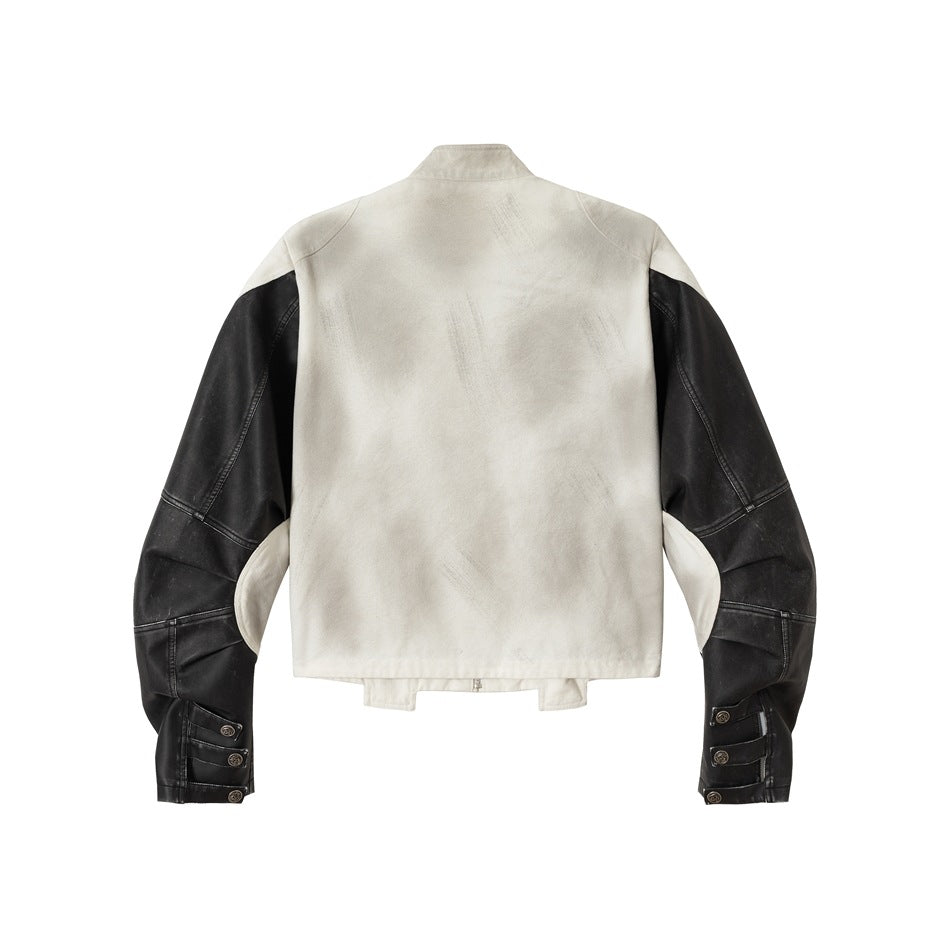 Back view of an off-white jacket with black paneled sleeves, a short stand collar and adjustable cuff straps.