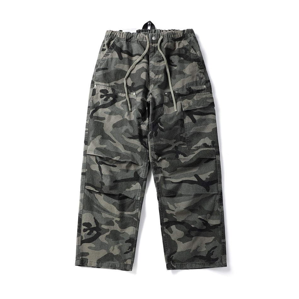 Gray camouflage wide-leg cargo pants with drawstring elastic waist and side cargo pocket, flat lay front view
