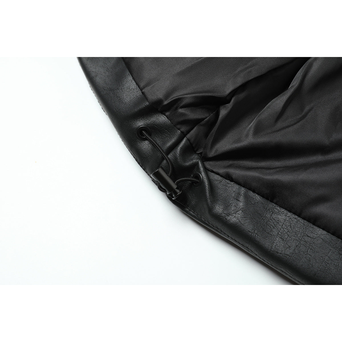 Close-up of the black jacket’s lining and adjustable drawcord at the hem.