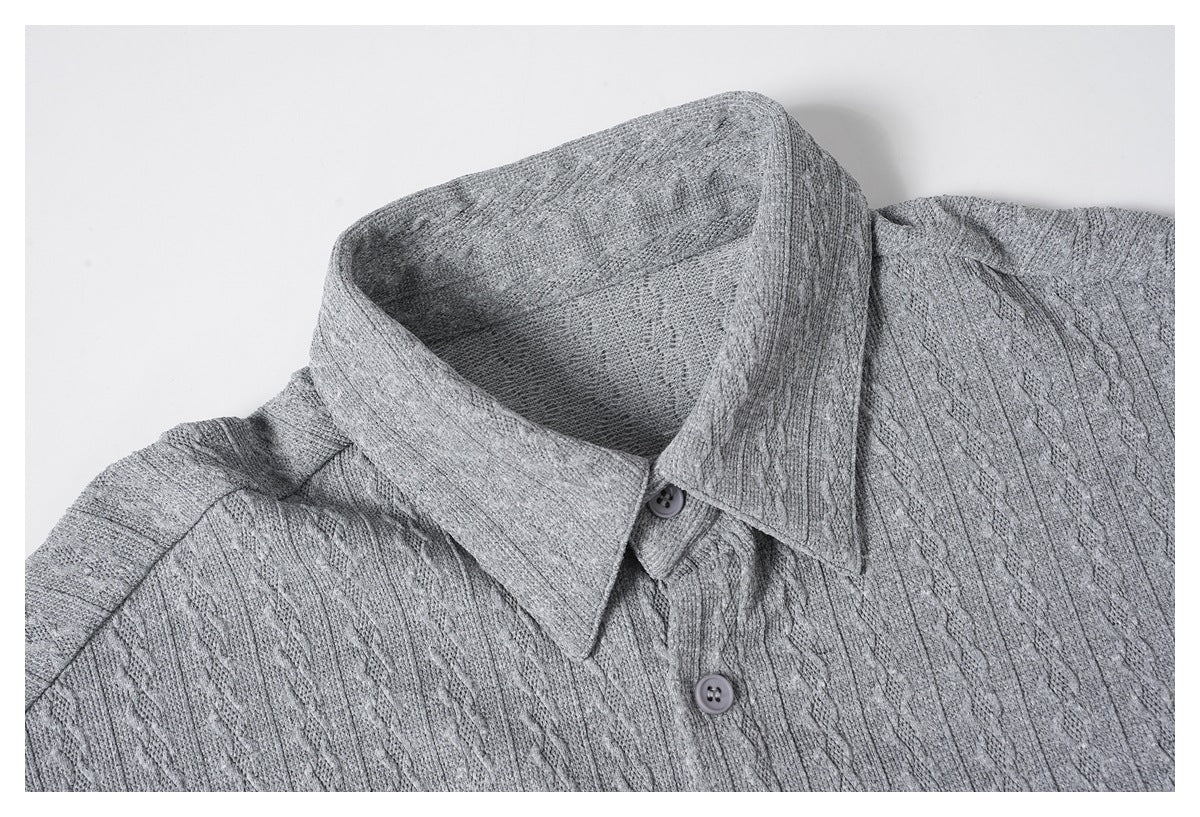 Close-up of a gray textured knit shirt showing its pointed collar and upper button placket.