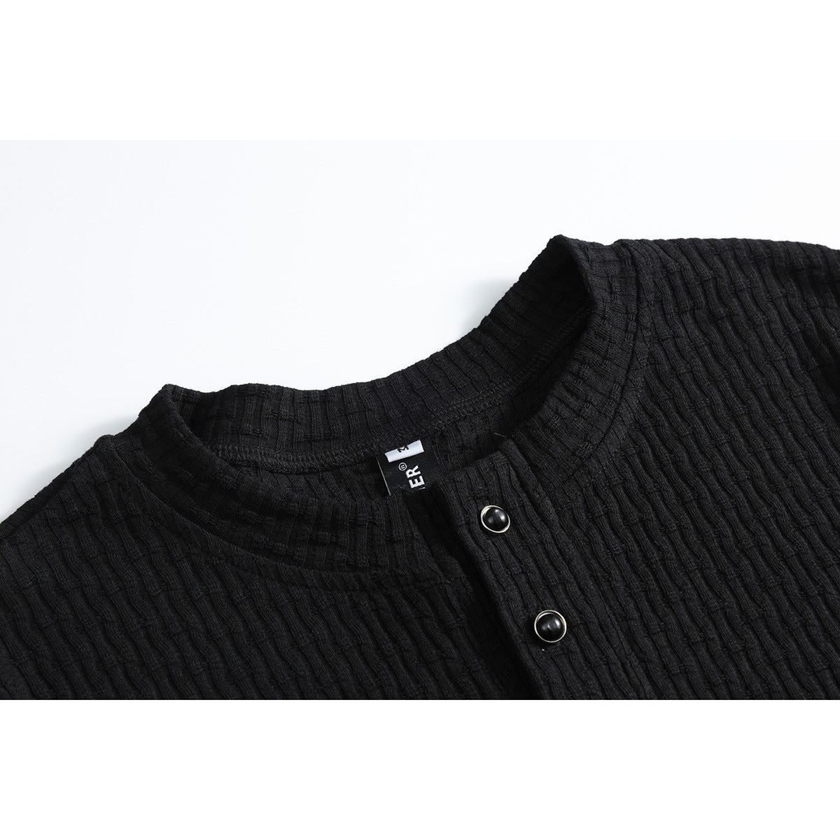 Close-up of a black ribbed shirt's stand collar and two dark buttons.