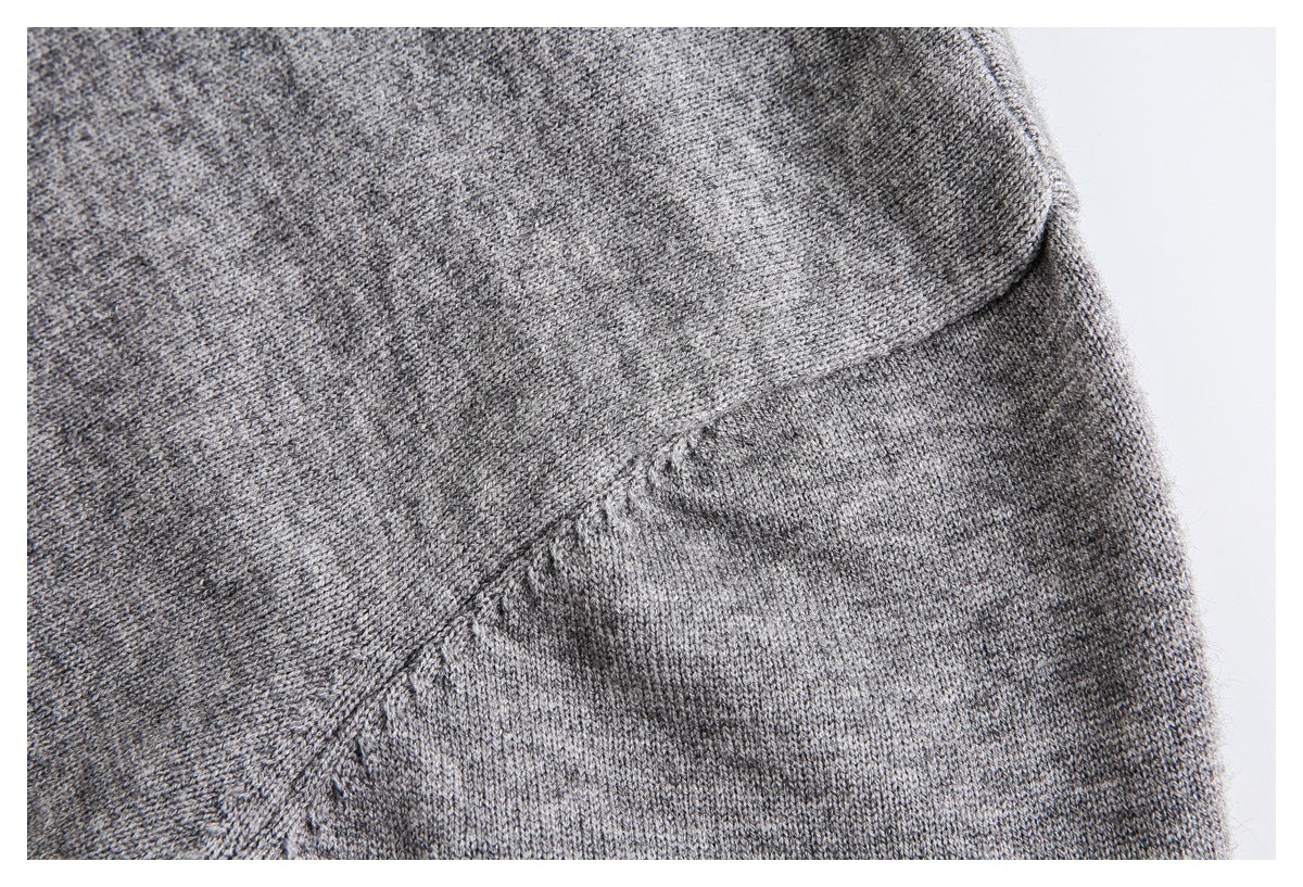 Close-up of gray marled knit fabric and a diagonal seam.