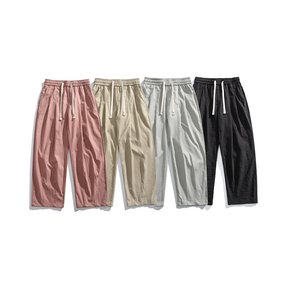 Five pairs of wide-leg drawstring pants shown together in dusty rose, beige, light gray, pale blue-gray, and black.