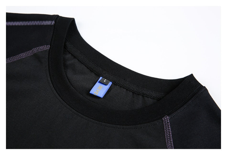 Close-up of a black crew neckline, purple seam stitching, and a blue neck label with a size L tag.