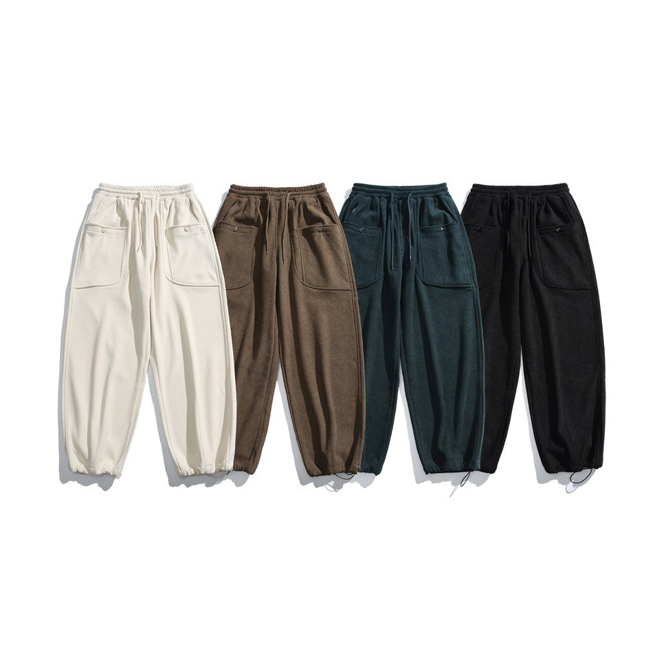 Four pairs of wide-leg drawstring pants with large pockets in ivory, brown, dark teal, and black.