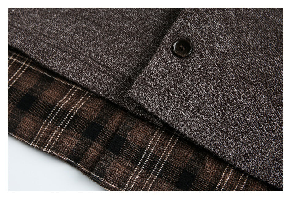 Close-up of a dark button on brown jacket fabric, with brown plaid lining visible at the edge.