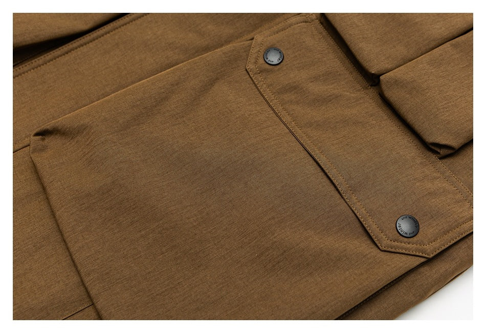 Close-up of the brown coat's front fabric, seam, and flap with two dark buttons.