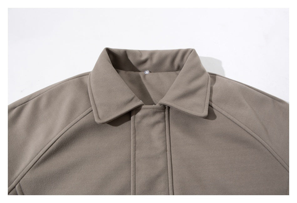 Close-up of a taupe jacket's wide collar and concealed front placket.